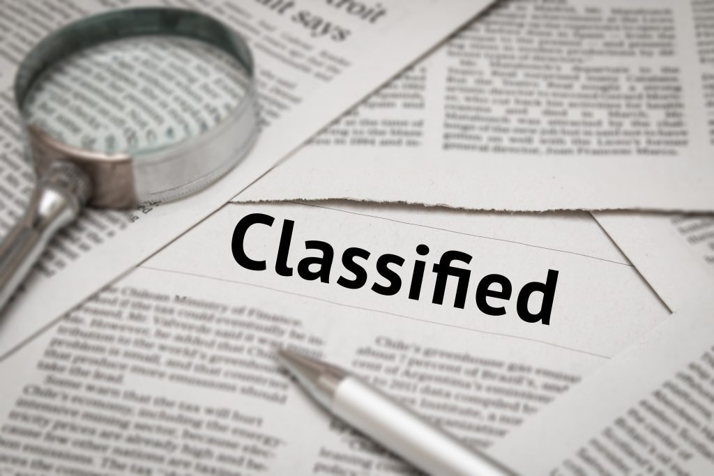 classified headline on newspaper background Benefits of Posting Classified Ads