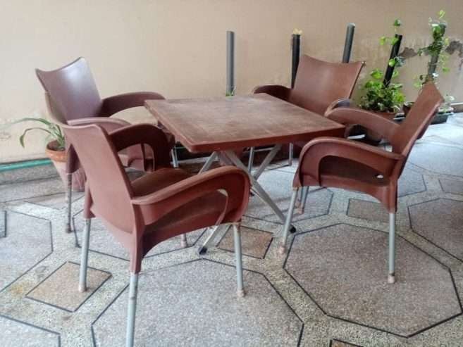 Used Out Door Plastic Chairs and Table Set Brown